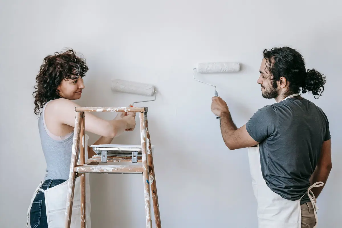 People painting a wall together — painting help in Toledo